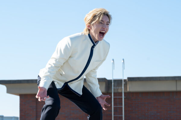 白い学ラン姿で屋上から叫ぶようなポーズを取る道枝駿佑。映画やドラマでの熱演によって年収が大きく伸びた時期をイメージさせる場面写真